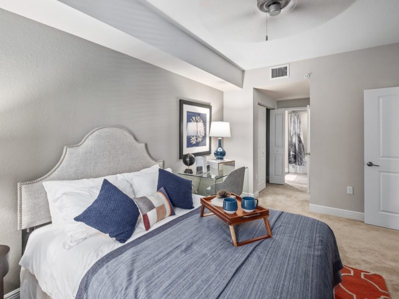 This image shows an expansive view of the Premium Apartment Feature, specifically the bedroom with a blue pillow on the bed, that was accessible to the bathroom.