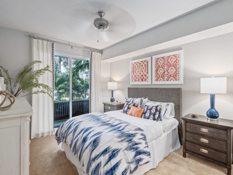This image shows the premium feature in the bedroom area with the modern touch of fabrics and offers a ceiling fan for a pleasant ambiance. This area was also accessible to the private patio that overlooks the waterfront view.