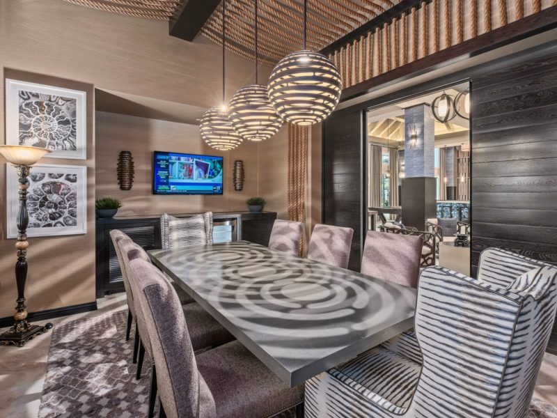 This image shows the view inside the business center in TGM Harbor Beach Apartment with luxurious items of furniture and light effects to the area.