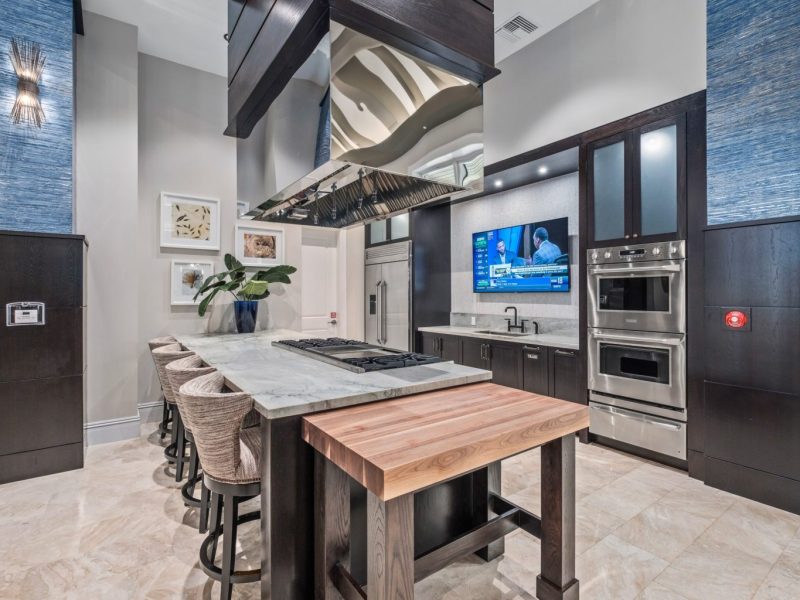 This image shows the view inside the gourmet demonstration kitchen in TGM Harbor Beach Apartment, featuring different kitchen equipment and a spacious area for an accessible treat.